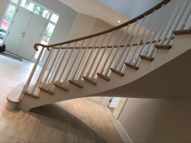 Curved staircase — White oak handrail and treads · paint-grade poplar
